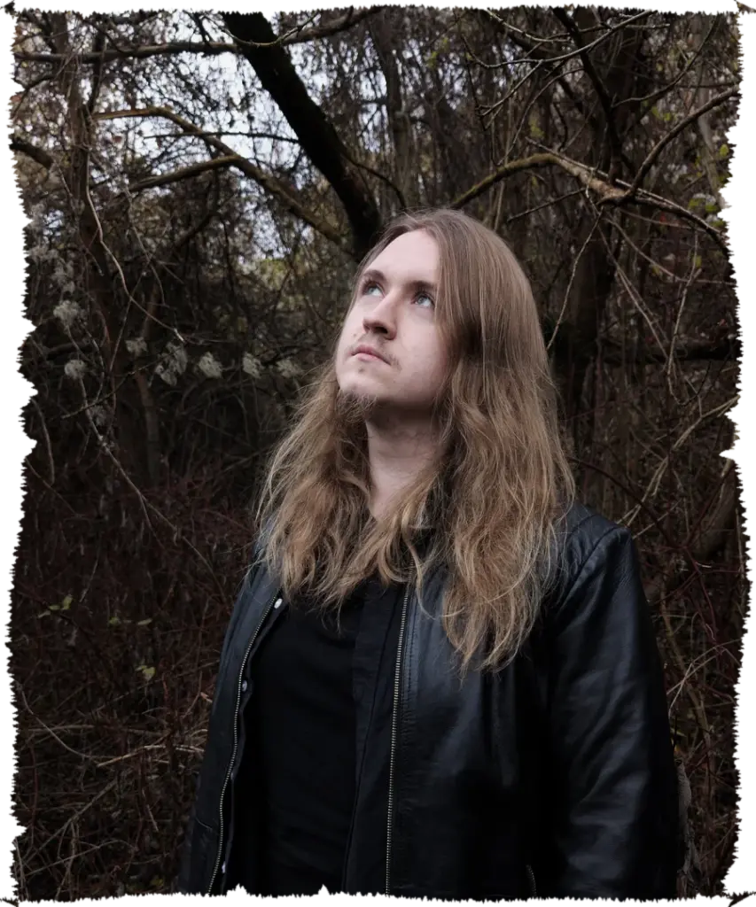 Krystian Jurkiewicz looking up among the trees